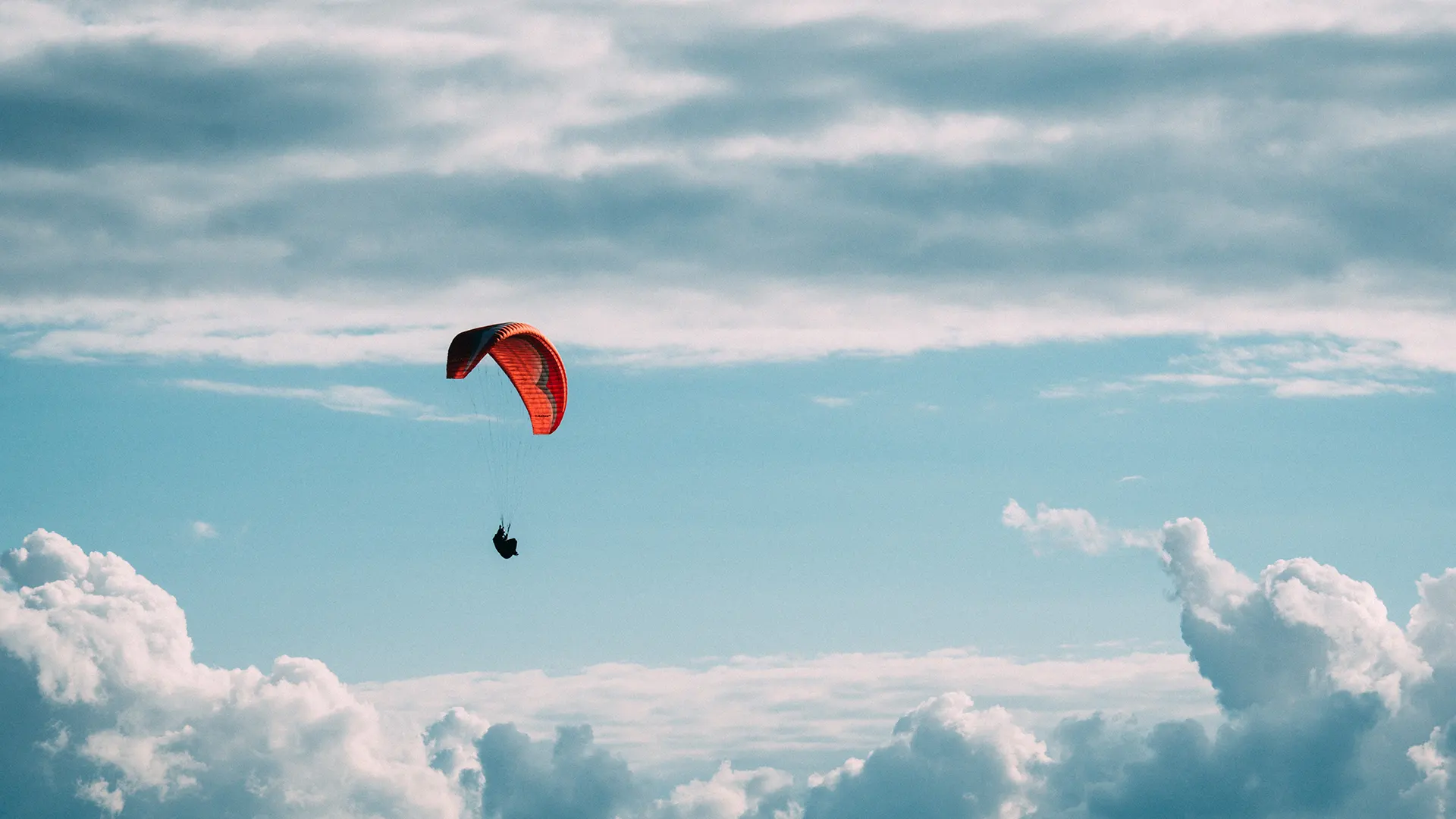 una persona con paracadute aperto in volo nel cielo